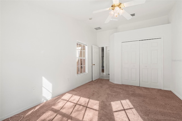 unfurnished bedroom featuring carpet, a closet, and ceiling fan