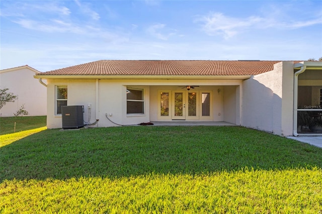 back of property with a lawn, ceiling fan, a patio, and central AC unit