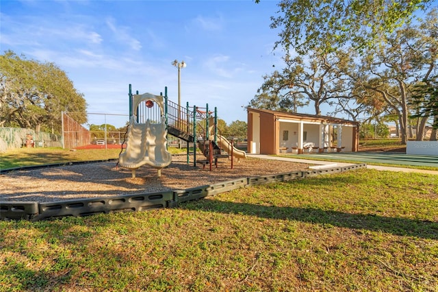 view of jungle gym featuring a lawn