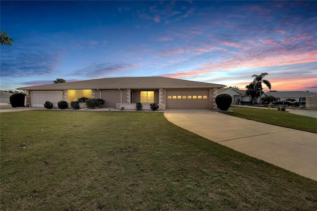 view of front facade with a lawn and a garage