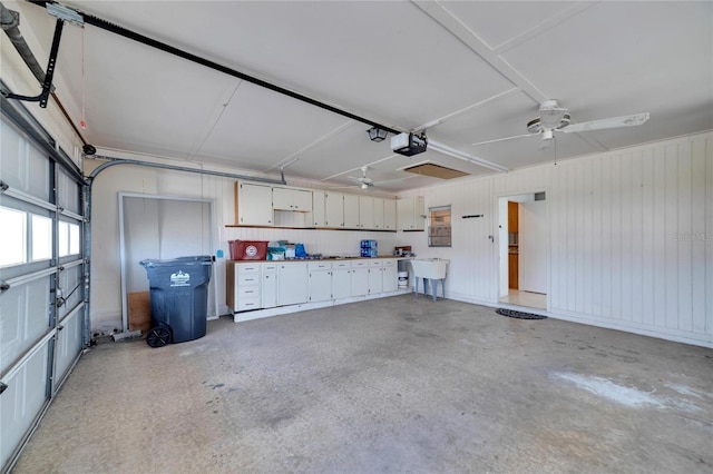 garage with ceiling fan, sink, and a garage door opener