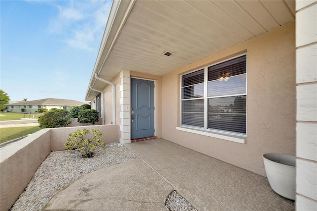 view of exterior entry with a porch