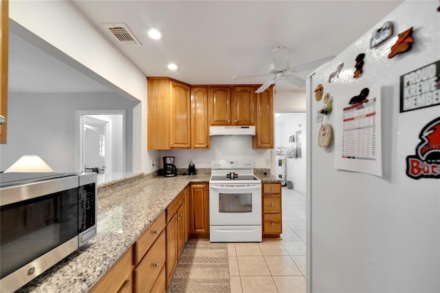 kitchen with refrigerator, light stone counters, ceiling fan, light tile patterned floors, and electric range