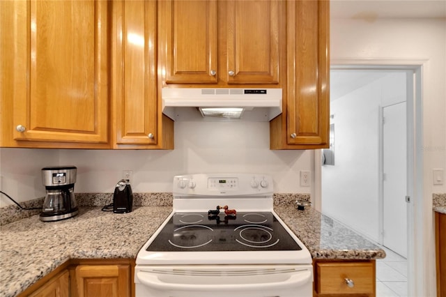 kitchen featuring tile patterned flooring, white electric stove, and light stone counters