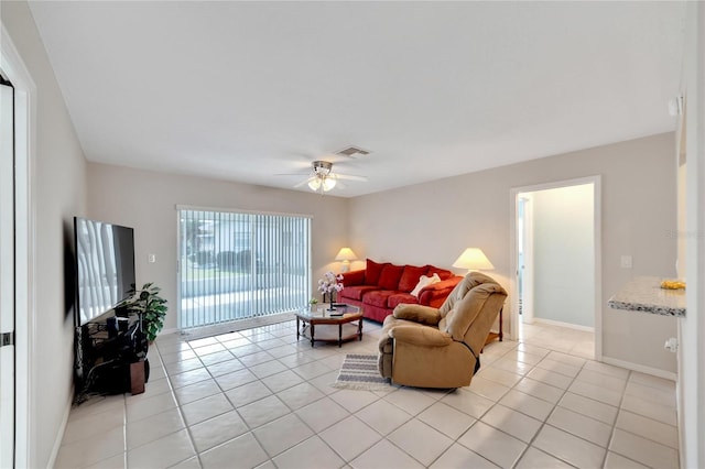 tiled living room featuring ceiling fan