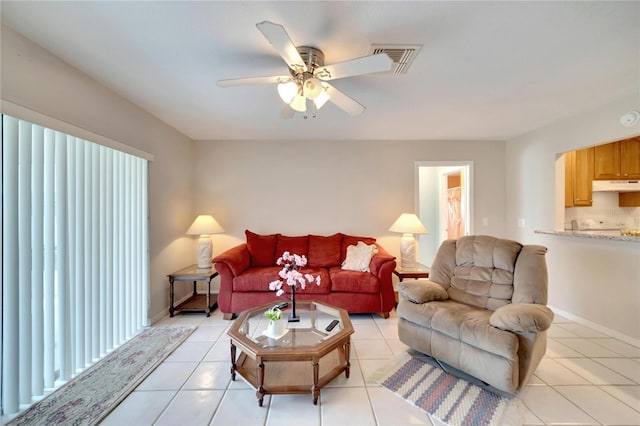 tiled living room with ceiling fan