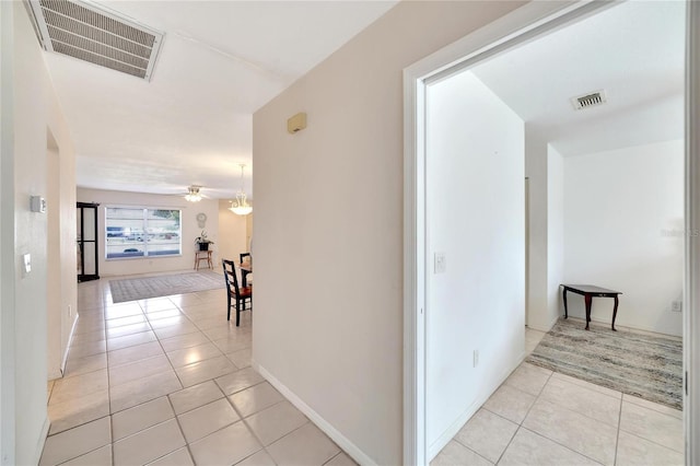 hall featuring light tile patterned floors