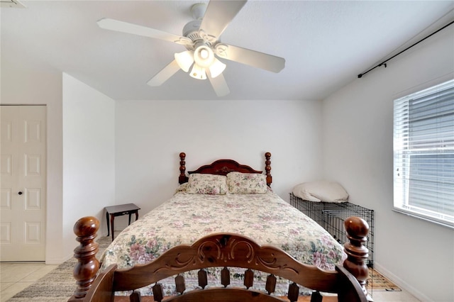 tiled bedroom featuring ceiling fan