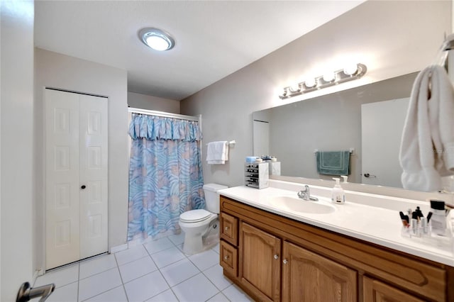 bathroom featuring tile patterned flooring, vanity, and toilet