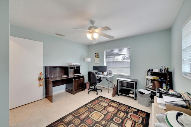 office area with light tile patterned floors and ceiling fan