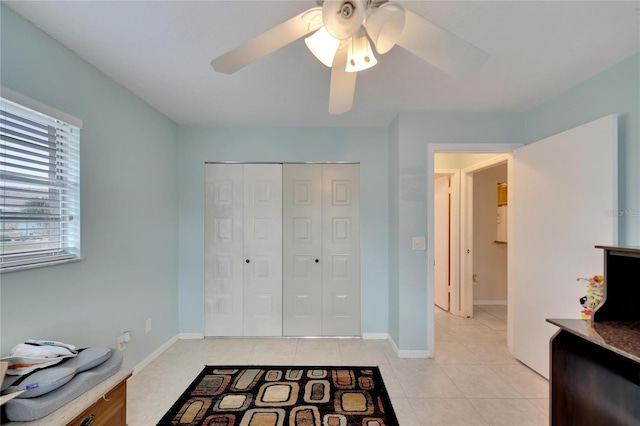 interior space featuring light tile patterned floors and ceiling fan