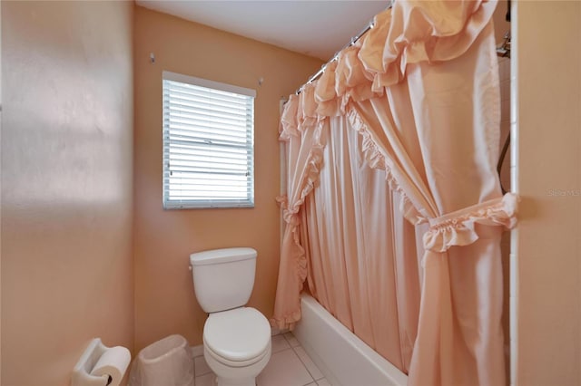 bathroom featuring tile patterned floors, toilet, and shower / bathtub combination with curtain