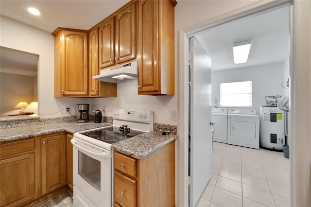 kitchen featuring light stone counters, electric water heater, washing machine and clothes dryer, white range with electric cooktop, and light tile patterned flooring