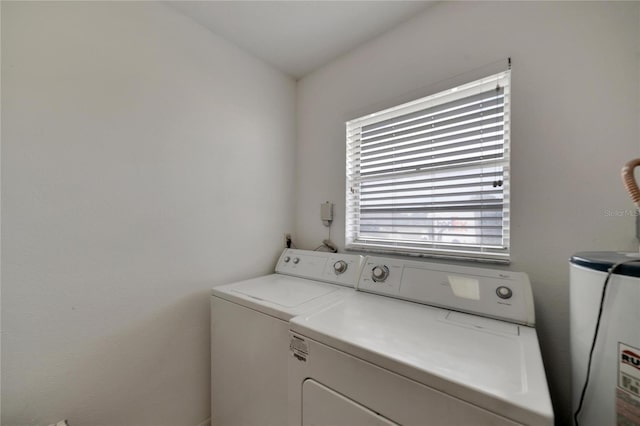 washroom featuring water heater and washing machine and clothes dryer