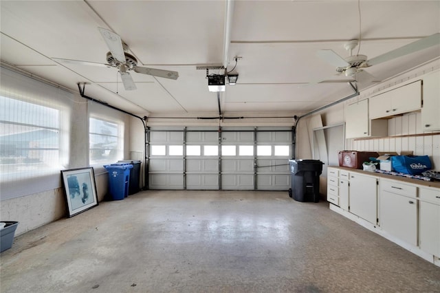 garage with ceiling fan and a garage door opener