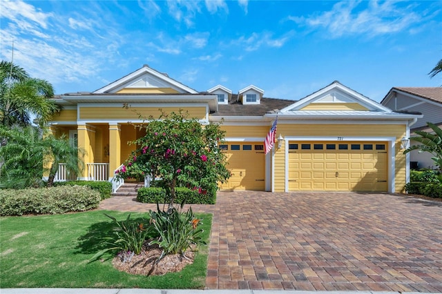 view of front of property with a porch and a garage