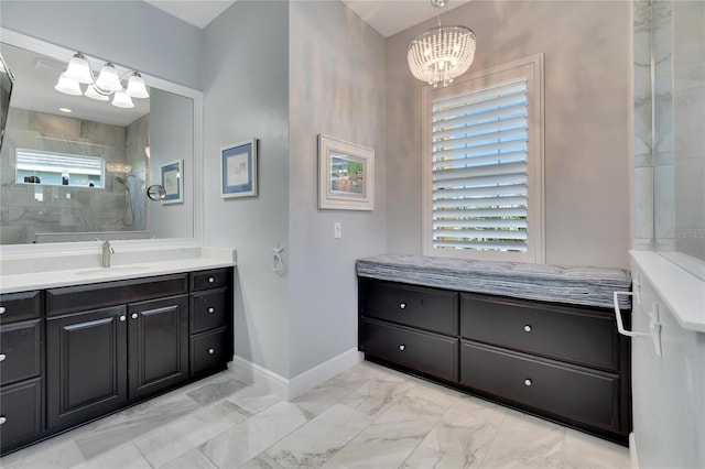 bathroom with a chandelier, a tile shower, and vanity