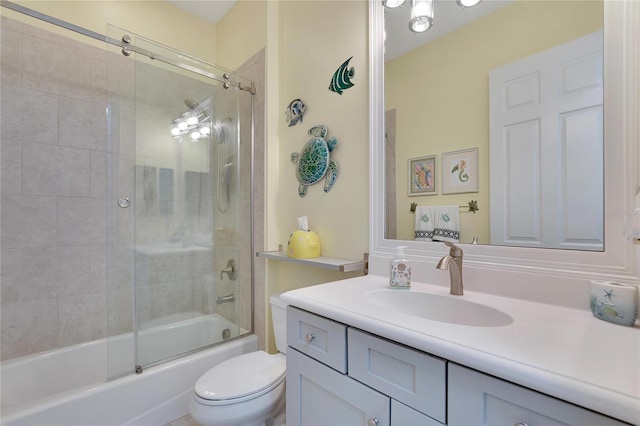 full bathroom with vanity, toilet, and bath / shower combo with glass door