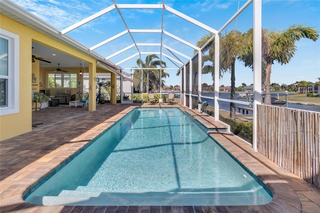 view of swimming pool with glass enclosure and a patio