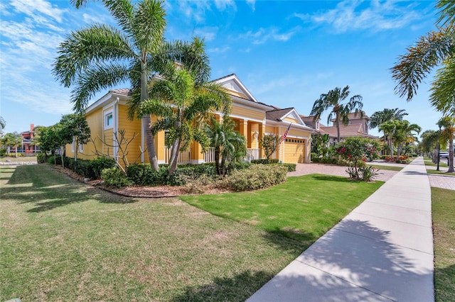 view of front of property with a porch, a front yard, and a garage