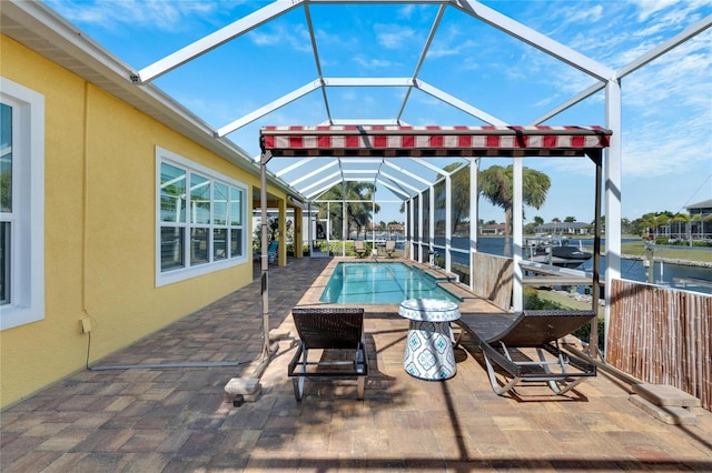 view of swimming pool featuring a water view, glass enclosure, and a patio area