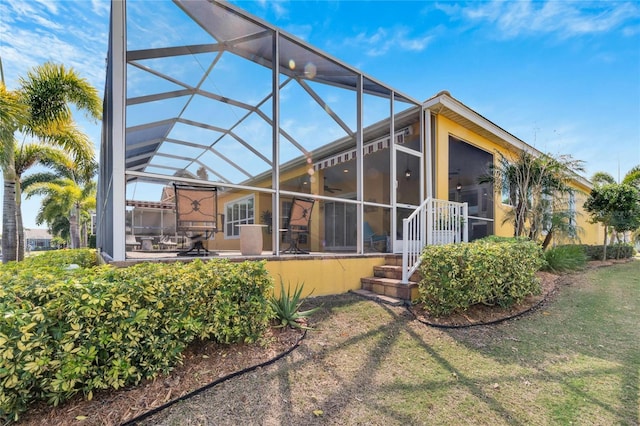721 Manns Harbor Dr, Apollo Beach, FL 33572 - back of house with ceiling fan, a patio, a lanai, and a lawn