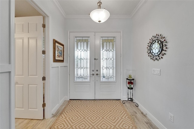 721 Manns Harbor Dr, Apollo Beach, FL 33572 - foyer entrance featuring french doors, light wood-style floors, and ornamental molding