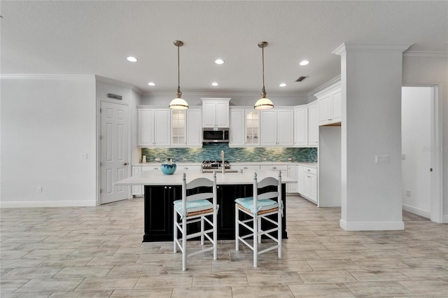 721 Manns Harbor Dr, Apollo Beach, FL 33572 - kitchen with appliances with stainless steel finishes, crown molding, light countertops, tasteful backsplash, and recessed lighting