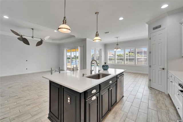721 Manns Harbor Dr, Apollo Beach, FL 33572 - kitchen featuring open floor plan, light countertops, stainless steel dishwasher, dark cabinetry, and a ceiling fan