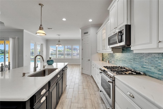 721 Manns Harbor Dr, Apollo Beach, FL 33572 - kitchen with stainless steel appliances, white cabinetry, tasteful backsplash, light countertops, and recessed lighting