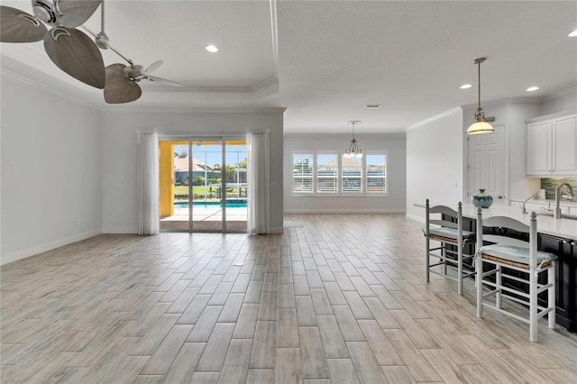 721 Manns Harbor Dr, Apollo Beach, FL 33572 - living room featuring crown molding, a ceiling fan, light wood-style flooring, a chandelier, and recessed lighting