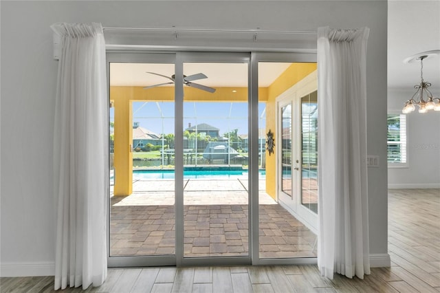 721 Manns Harbor Dr, Apollo Beach, FL 33572 - doorway with ceiling fan, a chandelier, wood finished floors, and french doors