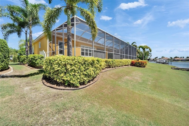 721 Manns Harbor Dr, Apollo Beach, FL 33572 - rear view of property with a yard, a water view, and a lanai
