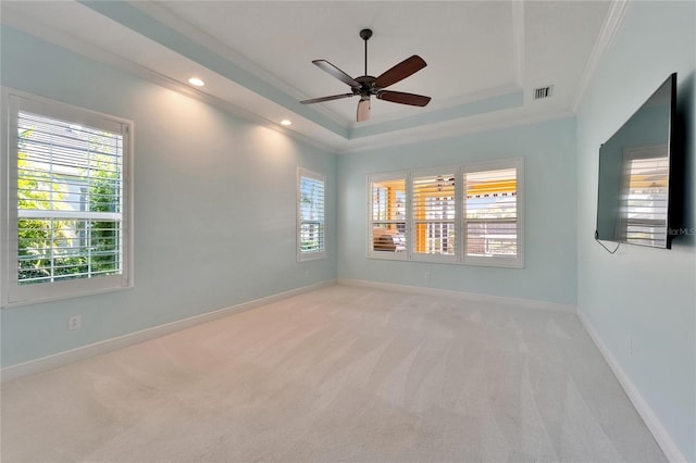 721 Manns Harbor Dr, Apollo Beach, FL 33572 - spare room featuring light carpet, a raised ceiling, ornamental molding, ceiling fan, and recessed lighting