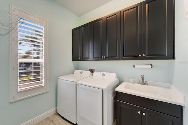 721 Manns Harbor Dr, Apollo Beach, FL 33572 - laundry room with cabinet space, separate washer and dryer, and light wood-type flooring