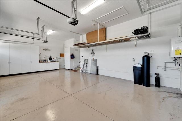 721 Manns Harbor Dr, Apollo Beach, FL 33572 - garage featuring a garage door opener and water heater