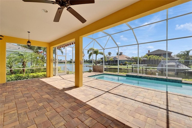 721 Manns Harbor Dr, Apollo Beach, FL 33572 - swimming pool with a patio, a water view, glass enclosure, and ceiling fan