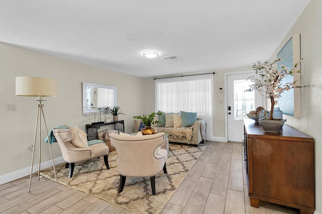 living room featuring plenty of natural light and light hardwood / wood-style floors