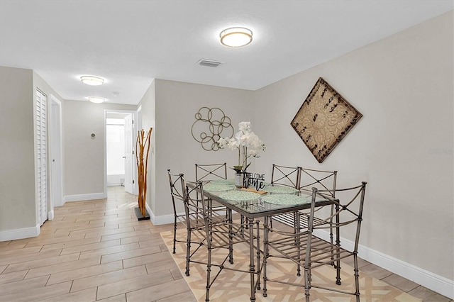 dining space with light hardwood / wood-style flooring