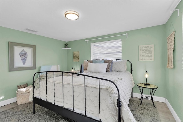 bedroom with hardwood / wood-style floors