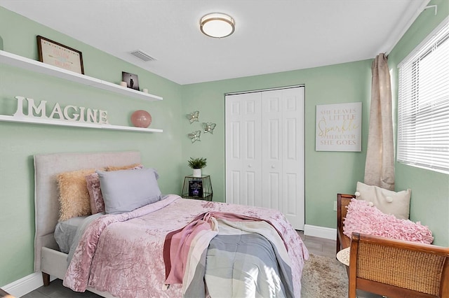 bedroom with hardwood / wood-style flooring and a closet