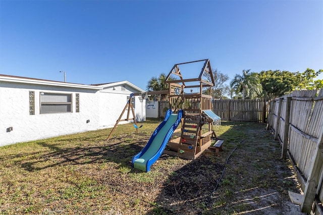 view of playground with a lawn