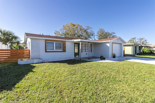 ranch-style home featuring a garage and a front yard