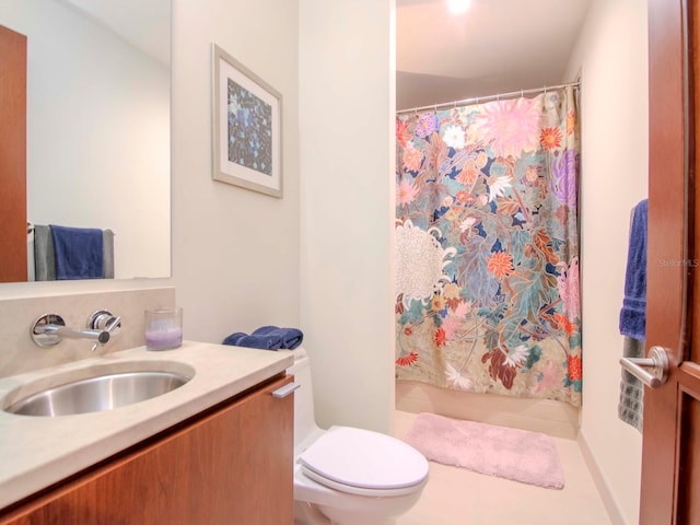 bathroom featuring tile patterned flooring, a shower with curtain, vanity, and toilet