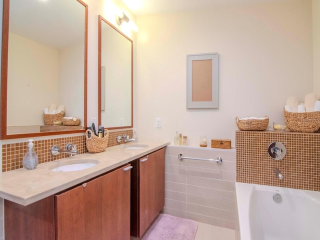 bathroom featuring tile patterned floors, vanity, and a bath