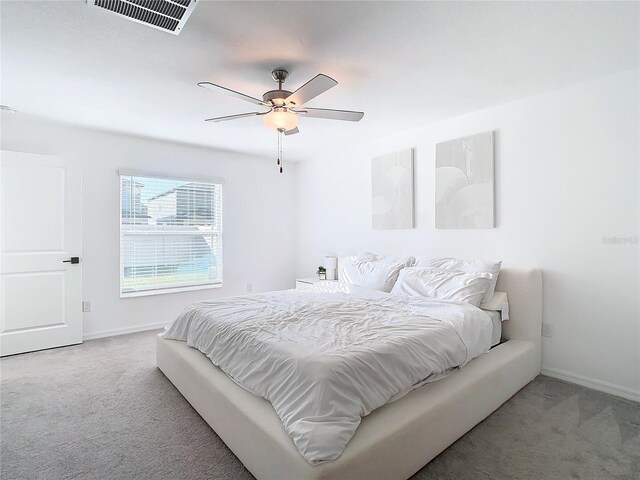 8849 Little Bluestem Dr, Land O Lakes, FL 34637 - carpeted bedroom with baseboards and ceiling fan