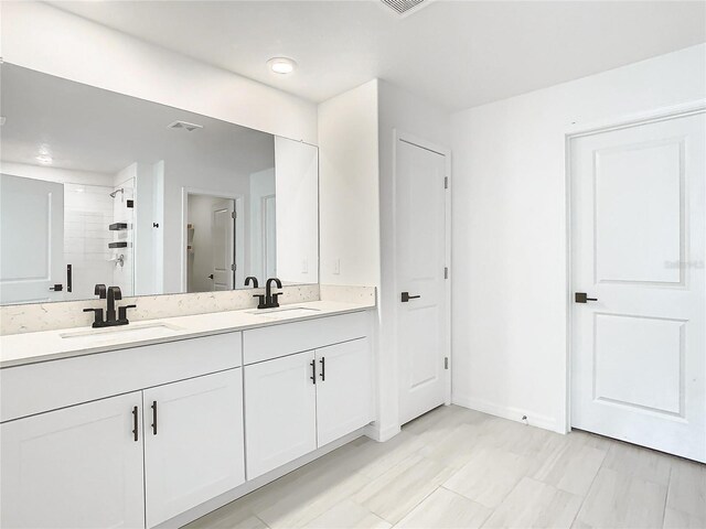 8849 Little Bluestem Dr, Land O Lakes, FL 34637 - full bath with double vanity, tiled shower, and baseboards