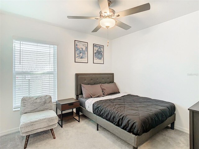 8849 Little Bluestem Dr, Land O Lakes, FL 34637 - bedroom featuring multiple windows, baseboards, and a ceiling fan