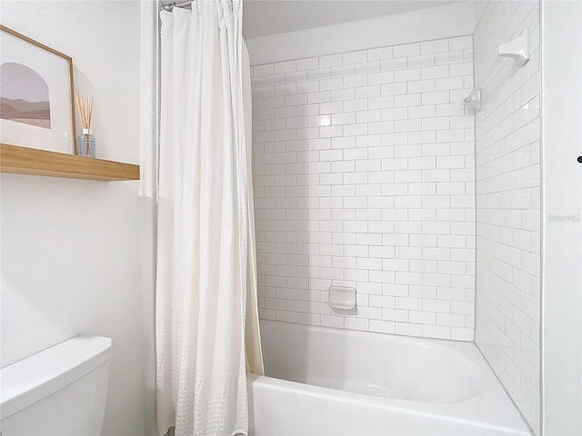 bathroom with shower / tub combo and toilet