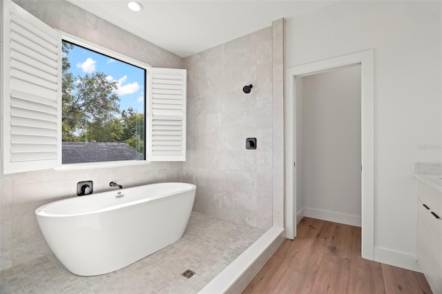 bathroom featuring vanity, shower with separate bathtub, and hardwood / wood-style flooring